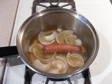 Bratwurst cooking in beer and onion