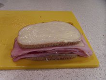 Buttered bread on an assembled ham on rye