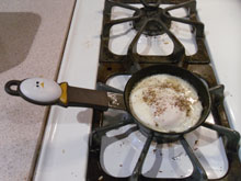 Fried egg cooking in a tiny skillet